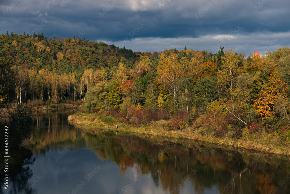 Fishing next to river in autumn in cloudy wheather