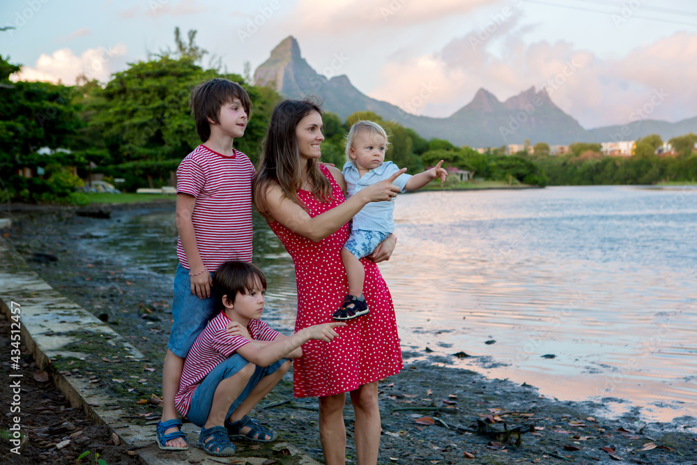Happy family, parents and children, enjoying aerial view of wild Mauritius mountains Happy family, parents and children, enjoying aerial view of wild Mauritius mountains