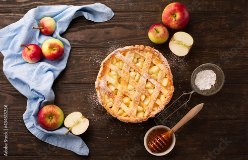 Homemade autumn apple pie on rustic wooden background.