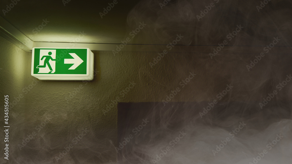 Emergency exit shows escape route in the event of smoke or fire - obrazy, fototapety, plakaty 