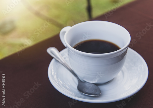 A cup of hot black coffee in the morning