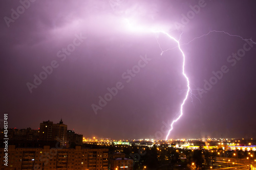 Lightning strike the ground in the city at night.