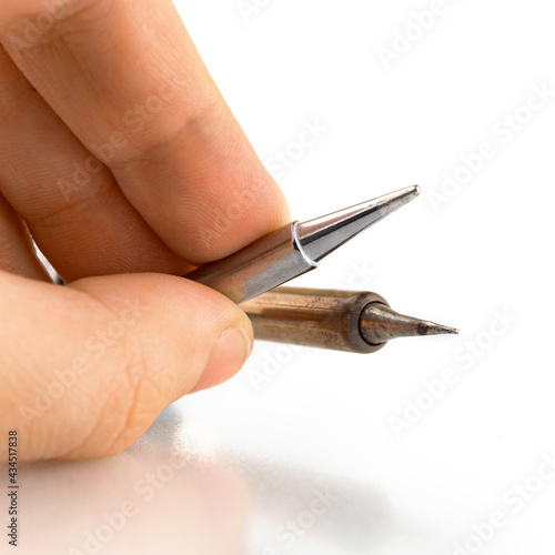 Man hold soldering iron tips isolated on a white background