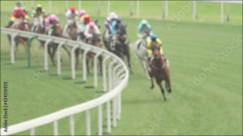 Unfocused shot of Horse race compete on a grass track. photo