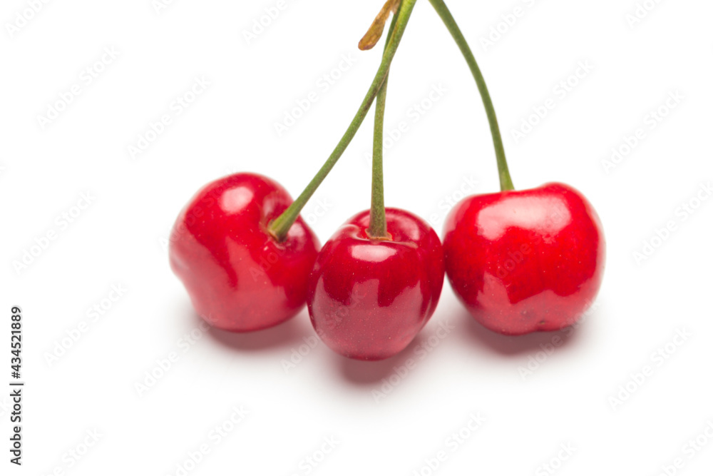 Small red cherries on a white background Small red cherries on a white background