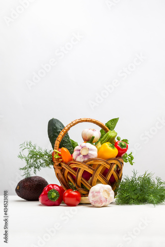 Vegetables in wicker basket. Pepper  cucumber  garlic  zucchini and dill on table..