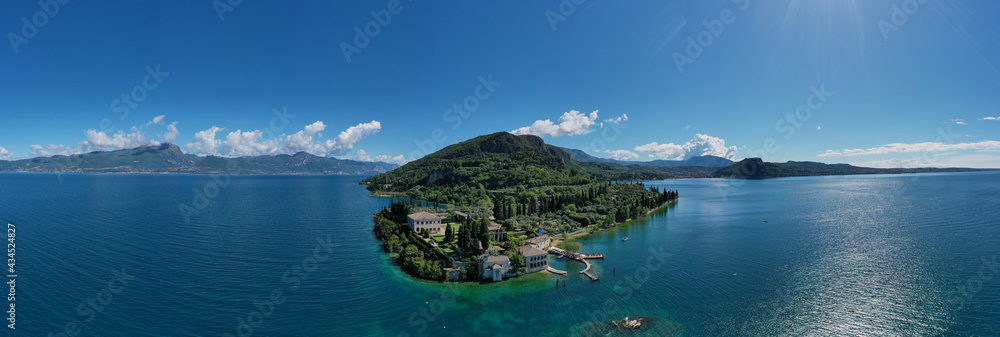 Panorama of punta san vigilio.  Aerial view of Parco Baia delle Sirene, Lake Garda, Italy. Top view of baia delle sirene on the coastline of Lake Garda. Baia delle Sirene on the coastline.
