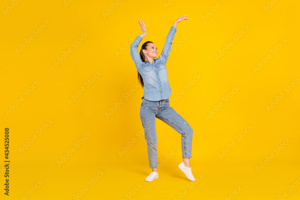 Full length body size photo young pretty girl dancing at party in jeans clothes isolated bright yellow color background
