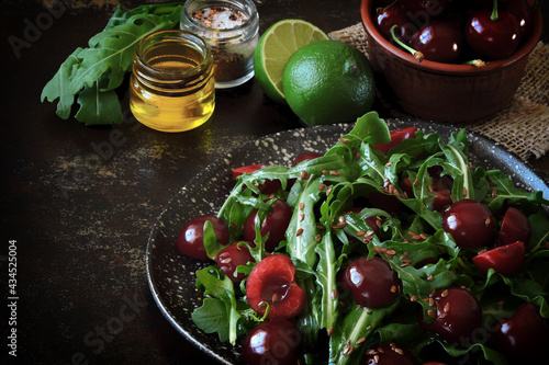 Healthy salad with arugula and sweet cherries. Diet salad.