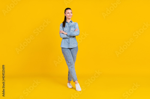 Full length body size view of attractive cheerful girl posing folded arms thinking copy space isolated over bright yellow color background