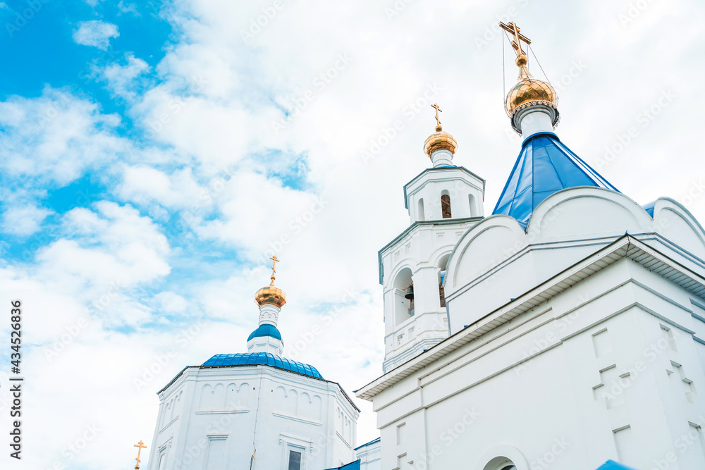 Orthodox church with blue domes against the blue sky