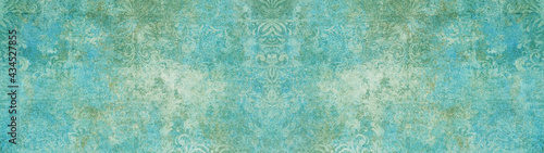 Old blue green vintage shabby patchwork damask ornate motif tiles stone concrete cement wall wallpaper texture background banner panorama long.