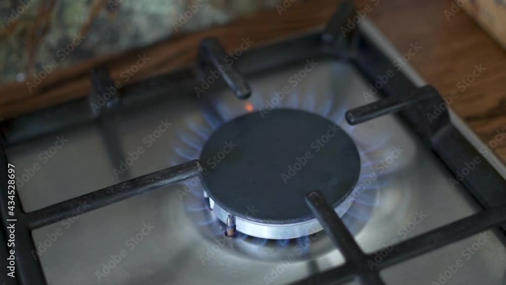 Blue Fire Gas Burner Stove, Macro, Close-up. The Cook Lights The Gas Stove. Blue Fire Gas Burner Stove, Macro, Close-up. The Cook Lights The Gas Stove.