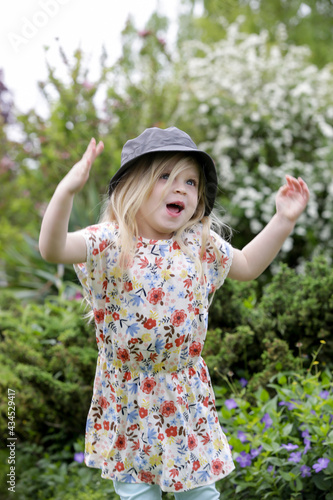 Active little toddler girl running and jumping in the park