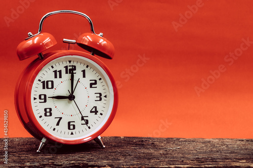 9 o'clock retro clock on wooden with red sun dusk dawn day sky background.