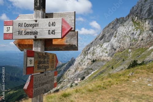 Arrows on a pole indicating the mountain paths of the Apuan Alps.The signs along the route indicate the mountain huts of Serenaia and Donegani.  photo