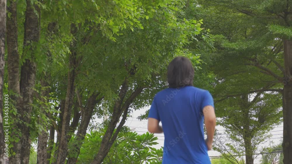 4K video Asian man running in the park . Concept for work out and healthy lifestyle. 4K video Asian man running in the park . Concept for work out and healthy lifestyle.