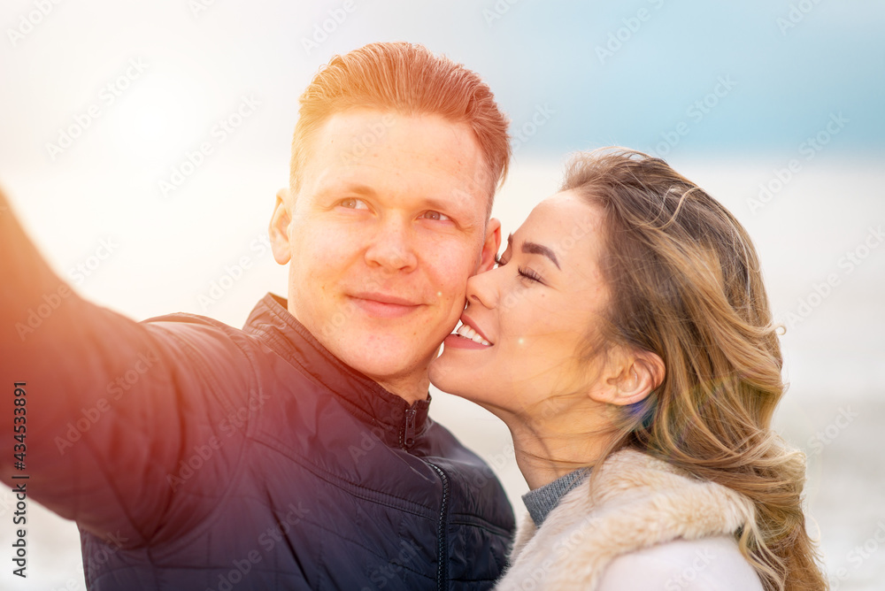 Happy romantic Smiling couple taking selfie on the sunny beach Happy romantic Smiling couple taking selfie on the sunny beach