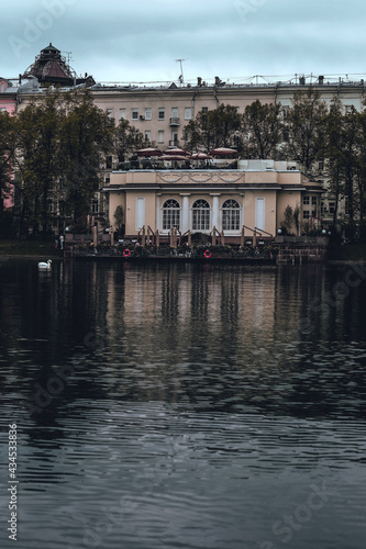 An old house with a summer veranda on the patriarch's ponds in the center of Moscow. Vertical