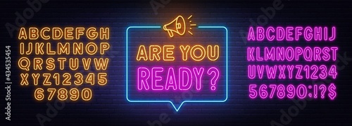 Are You Ready neon sign in the speech bubble on brick wall background.