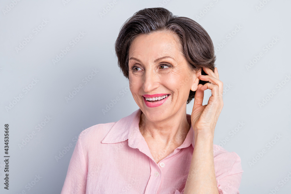 Photo of dreamy charming old woman look empty space good mood smile nice isolated on grey color background Photo of dreamy charming old woman look empty space good mood smile nice isolated on grey color background