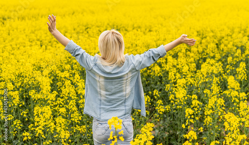 Portrait with a beautiful woman in rapeseed