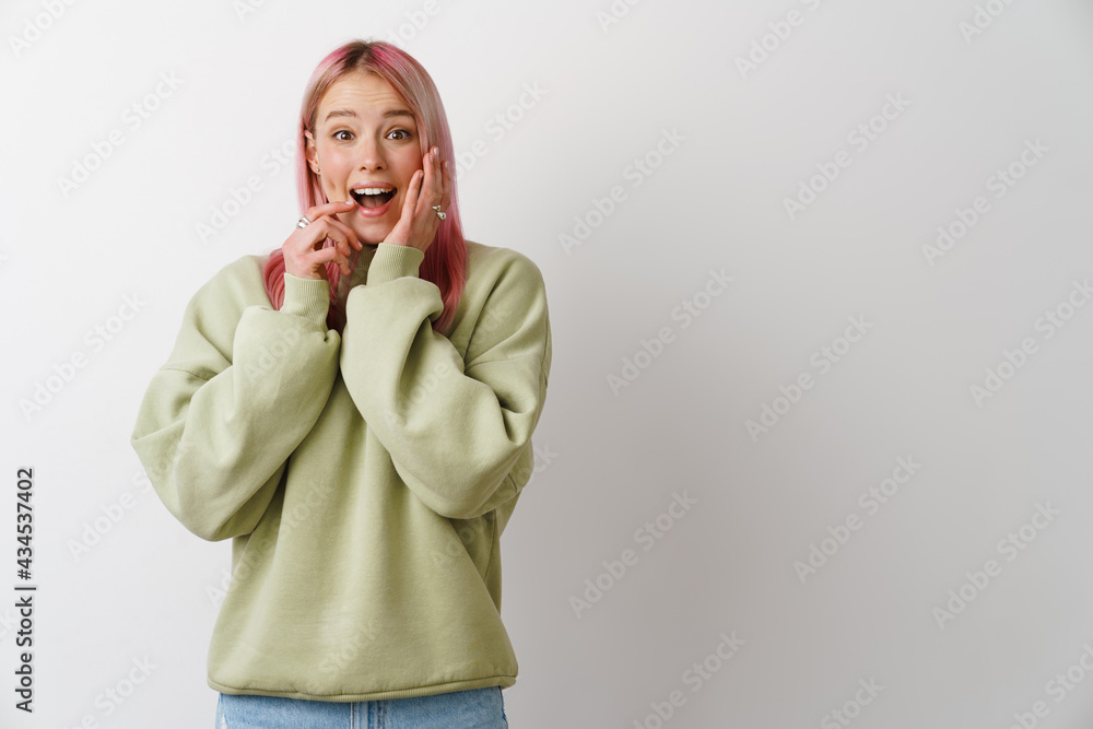 Young excited woman with pink hair expressing surprise at camera Young excited woman with pink hair expressing surprise at camera