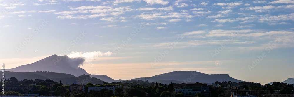 Sainte Victoire mountain, in the light of a spring morning, with a cloud hanging from the top