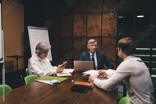 Calm colleagues having conversation on conference