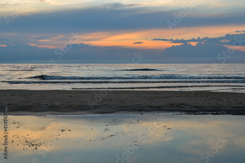 Wallpaper Mural red and orange dramatic sunset on the sea beach with colorful sky and waves crushing on the shore Torontodigital.ca