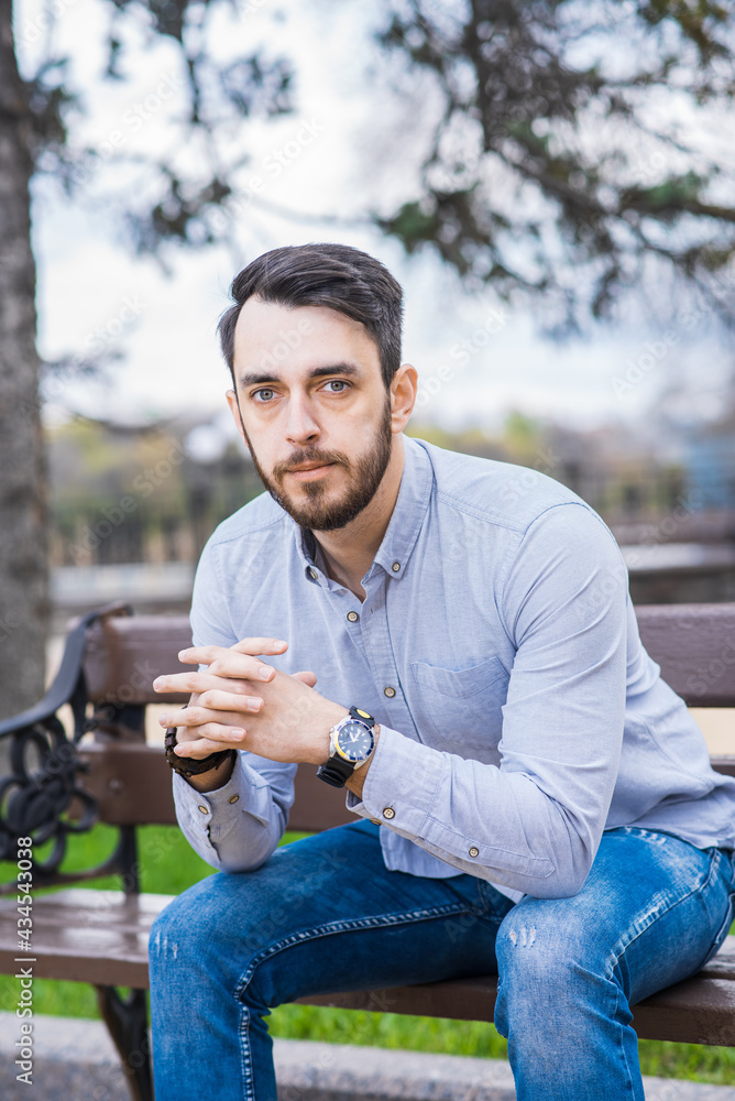 Portrait of a man who sits on a bench and thinks Portrait of a man who sits on a bench and thinks
