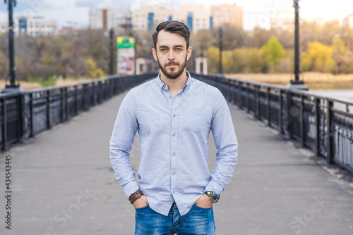 Portrait of a man businessman with a beard in a shirt while walking in the afternoon © Павел Костенко