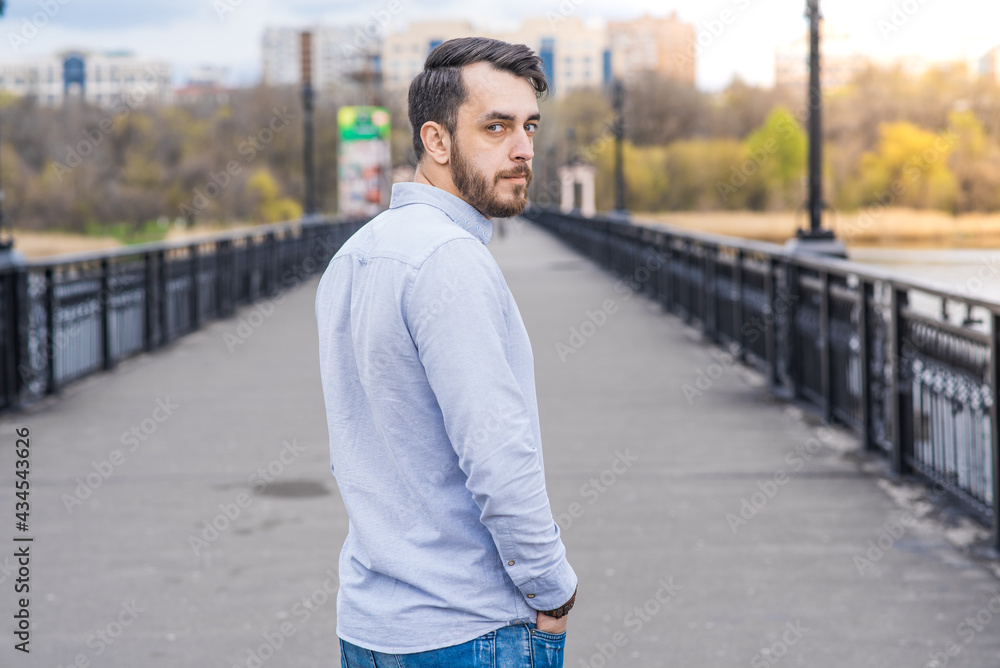 Portrait of a man businessman with a beard in a shirt while walking in the afternoon Portrait of a man businessman with a beard in a shirt while walking in the afternoon