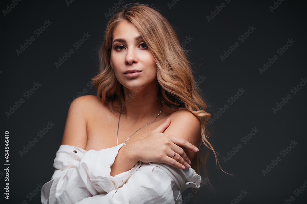 Naklejka premium Portrait of sexy young woman posing in white shirt 