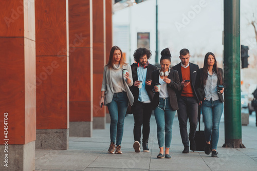 Elegant businesspeople walking in a modern city..