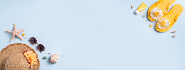 Summer beach background design concept with shells, hat, slipper on blue background.