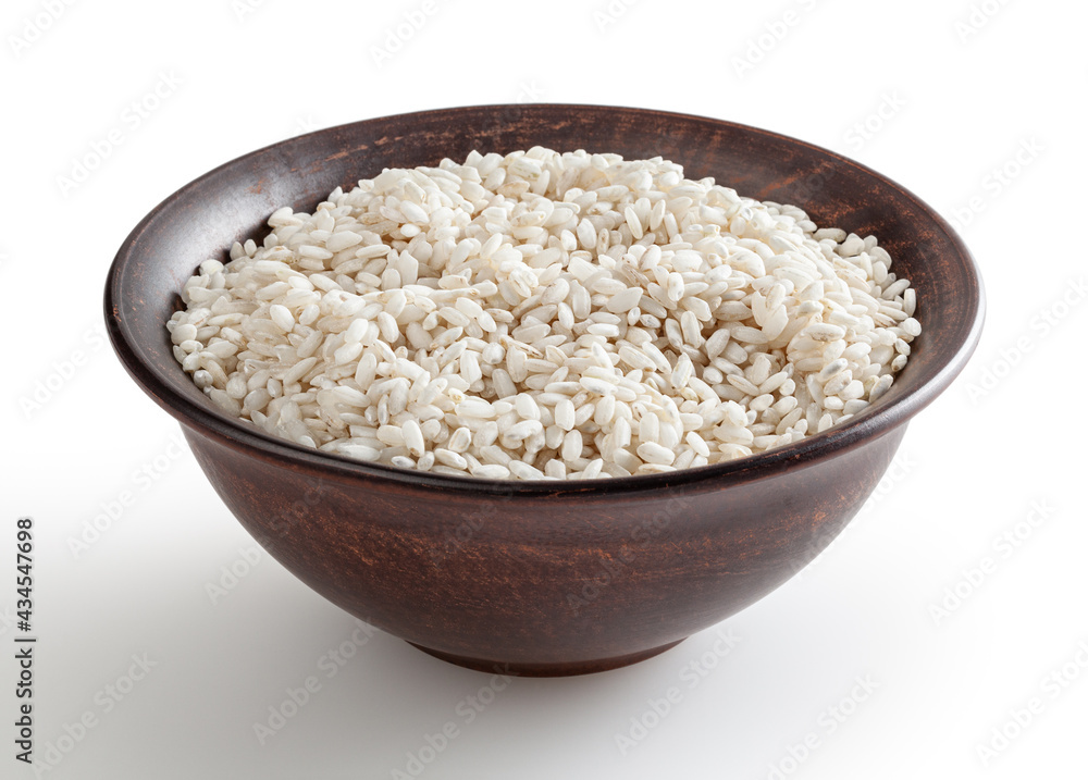 Uncooked arborio rice in ceramic bowl isolated on white background with clipping path Uncooked arborio rice in ceramic bowl isolated on white background with clipping path