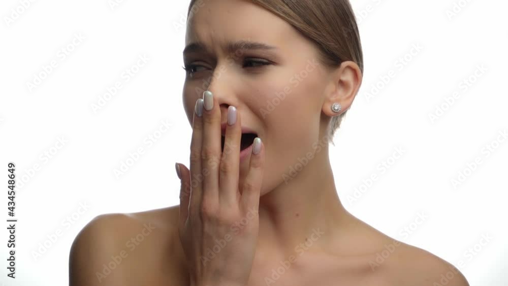 tired woman with bare shoulders yawning on white tired woman with bare shoulders yawning on white