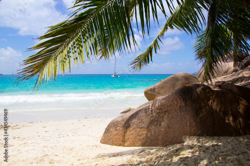 Beautiful beach with Palm Tree and ship on the Seychelles