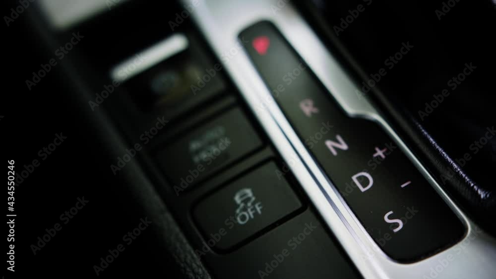 Man shifting gear, Close up of hand on automatic modern gear Man shifting gear, Close up of hand on automatic modern gear
