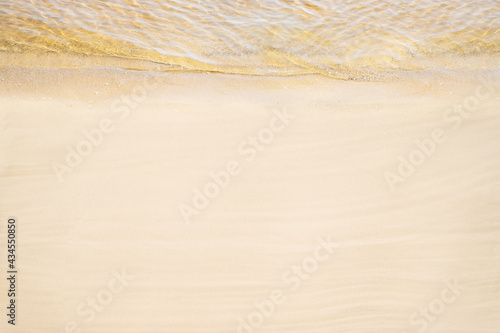 Top and aerial view on tropical sand beach with yellow sea. Ocean coastline. Drone photo. Background