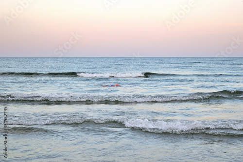 sunset on the beach - seascape, cloudscape - girl swimming in sea - Navodari, Constanta county, Dobrudja, Romania, Europe, Black Sea photo