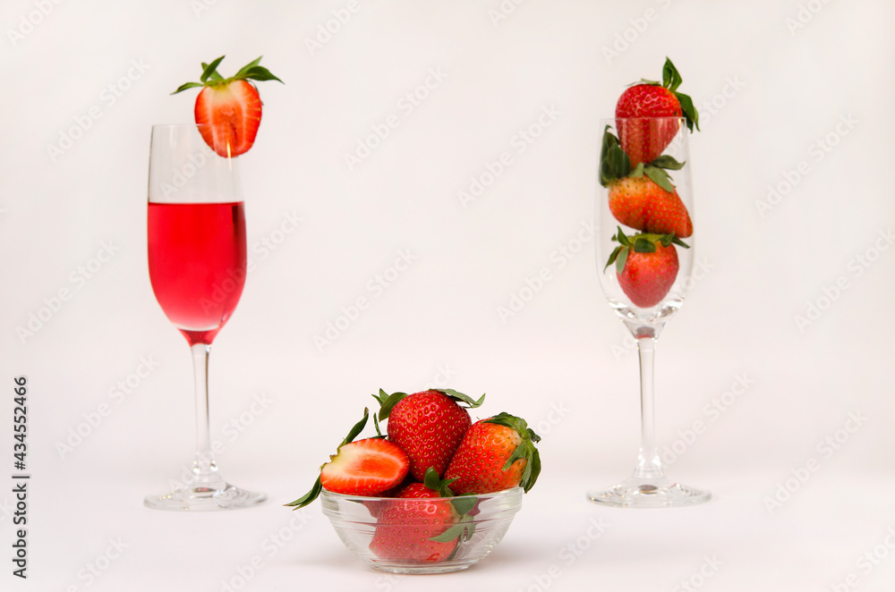 strawberries in a bowl and a glass with a strawberry drink strawberries in a bowl and a glass with a strawberry drink