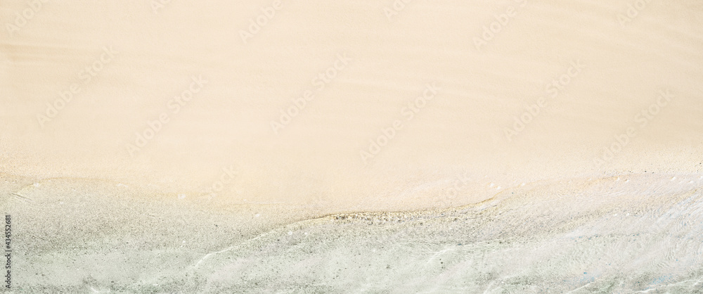 Top and aerial view on tropical sand beach with sea. Ocean coastline. Drone photo. Background. Panorama, 16:9