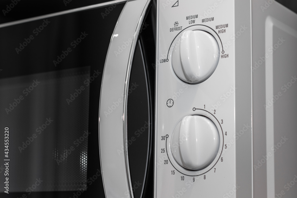 Close-up Control Panel of White Microwave in Kitchen, for Set the Temperature and Cooking Time. Close-up Control Panel of White Microwave in Kitchen, for Set the Temperature and Cooking Time.