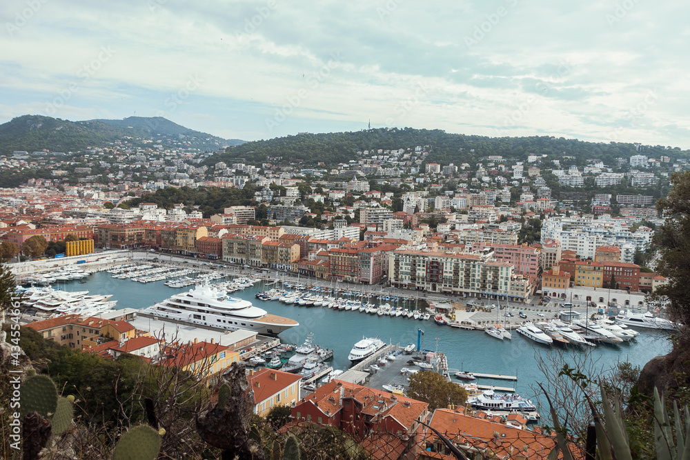 View of famous port of French riviera from top of castle hill in Nice, France at cloudy day in autumn. Lifestyle and travel concept. High quality image
