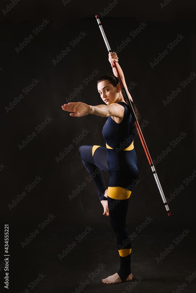Horting sports woman with stick doing different stance on black background Horting sports woman with stick doing different stance on black background
