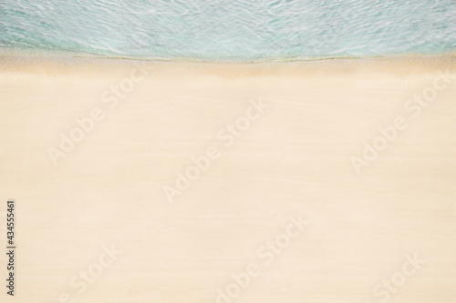 Fototapeta Naklejka Na Ścianę i Meble -  Top and aerial view on tropical sand beach with sea. Ocean coastline. Drone photo. Background