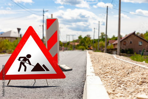 The traffic sign warns of works and reconstruction of roads