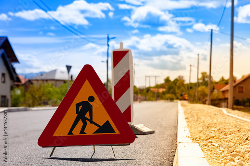 The traffic sign warns of works and reconstruction of roads